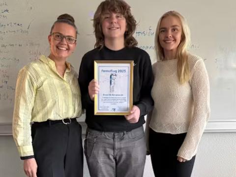 Aron with his award certificate