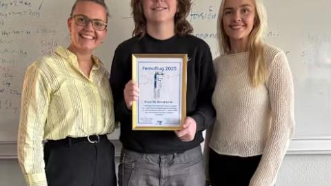 Aron with his award certificate